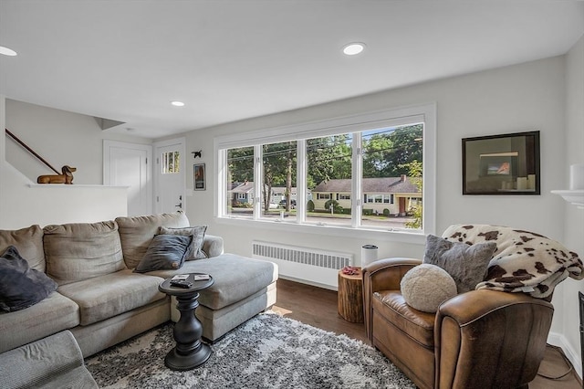 living room with dark wood-type flooring and radiator heating unit