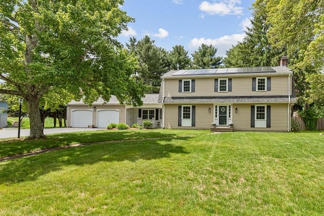 15 Bunny Ln, Brooklyn, CT 06234 - traditional-style house featuring driveway, solar panels, an attached garage, a front yard, and a chimney