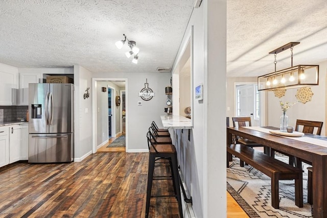 15 Bunny Ln, Brooklyn, CT 06234 - dining room featuring dark wood finished floors, a textured ceiling, and baseboards
