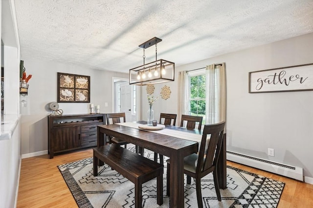 15 Bunny Ln, Brooklyn, CT 06234 - dining area featuring a baseboard radiator, light wood-style flooring, a textured ceiling, and baseboards