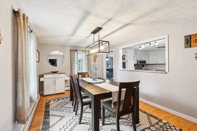 15 Bunny Ln, Brooklyn, CT 06234 - dining room with light wood-style flooring, a textured ceiling, baseboards, and rail lighting