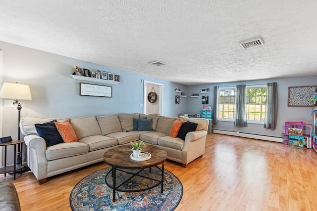 15 Bunny Ln, Brooklyn, CT 06234 - living area with a baseboard heating unit, a textured ceiling, and light wood-style flooring