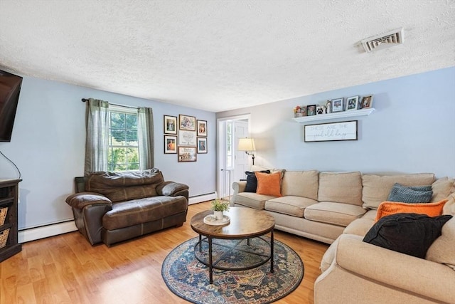 15 Bunny Ln, Brooklyn, CT 06234 - living room with baseboard heating, a textured ceiling, and wood finished floors