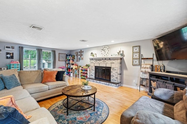 15 Bunny Ln, Brooklyn, CT 06234 - living room featuring a brick fireplace, wood finished floors, a textured ceiling, baseboards, and recessed lighting