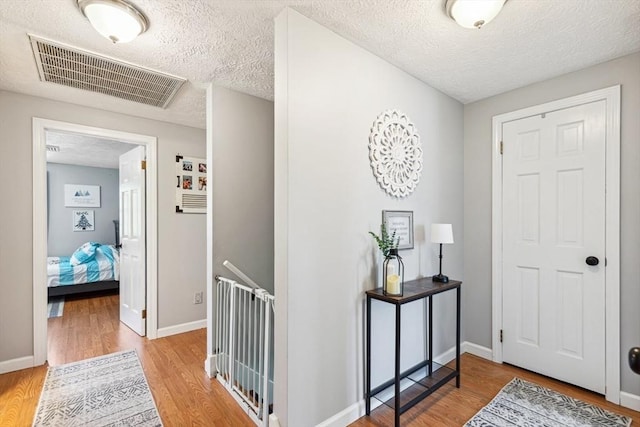 15 Bunny Ln, Brooklyn, CT 06234 - entrance foyer featuring a textured ceiling, light wood-type flooring, and baseboards
