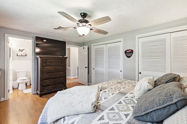 15 Bunny Ln, Brooklyn, CT 06234 - bedroom with two closets, wood finished floors, a textured ceiling, ensuite bath, and ceiling fan