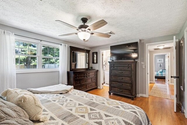 15 Bunny Ln, Brooklyn, CT 06234 - bedroom featuring light wood-type flooring, a textured ceiling, a ceiling fan, and connected bathroom