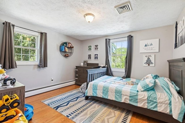 15 Bunny Ln, Brooklyn, CT 06234 - bedroom with a baseboard radiator, wood finished floors, and a textured ceiling
