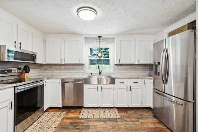 15 Bunny Ln, Brooklyn, CT 06234 - kitchen featuring stainless steel appliances, a sink, dark wood-style flooring, white cabinetry, and a textured ceiling