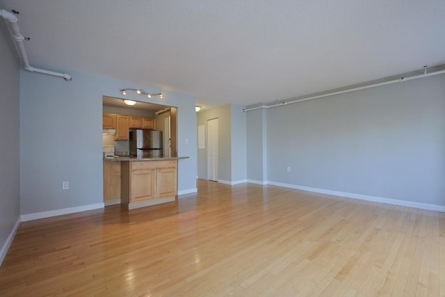 872 Massachusetts Ave Unit 401, Cambridge, MA 02139 - unfurnished living room with light wood-style floors