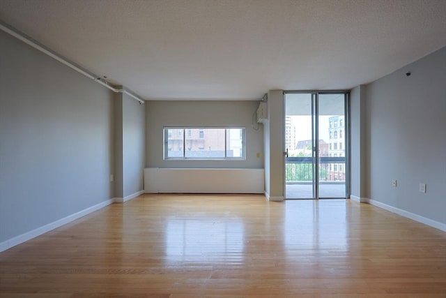 872 Massachusetts Ave Unit 401, Cambridge, MA 02139 - spare room with light wood-style flooring and baseboards