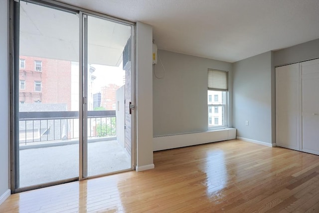 872 Massachusetts Ave Unit 401, Cambridge, MA 02139 - unfurnished bedroom featuring access to outside and light wood-style flooring
