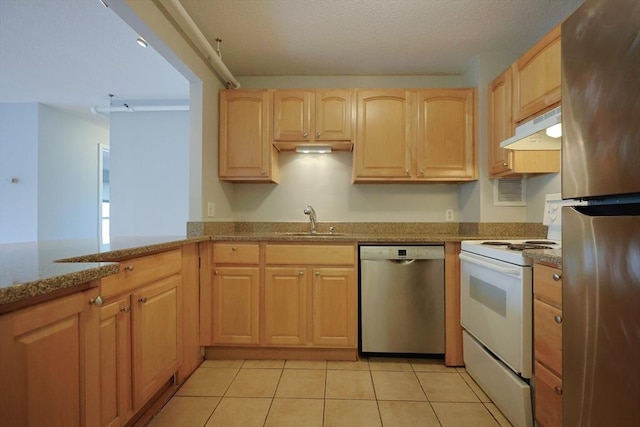 872 Massachusetts Ave Unit 401, Cambridge, MA 02139 - kitchen featuring stainless steel appliances, under cabinet range hood, light brown cabinets, and light stone countertops