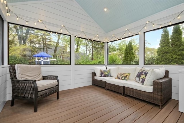 sunroom with lofted ceiling and outdoor lounge area