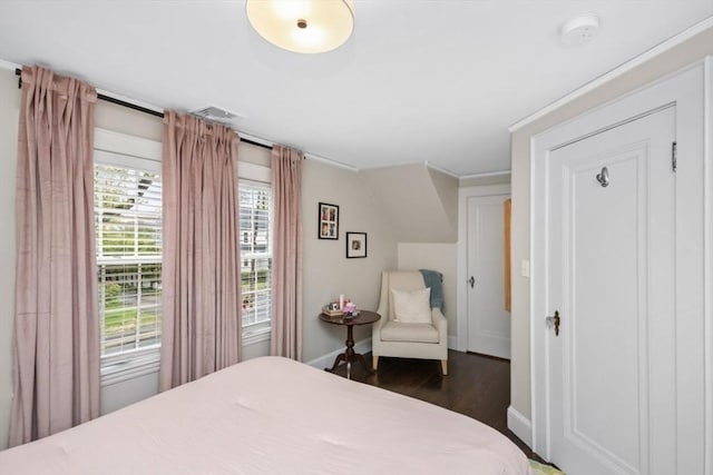bedroom featuring wood finished floors and baseboards
