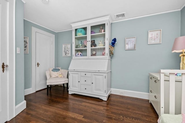 bedroom with ornamental molding, baseboards, and dark wood finished floors