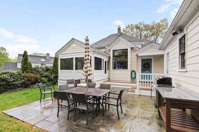 view of patio with outdoor dining area and grilling area