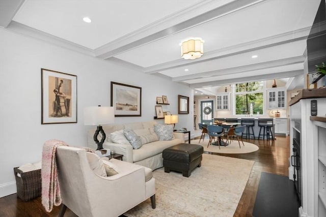 living area with wood finished floors, beam ceiling, recessed lighting, baseboards, and ornamental molding