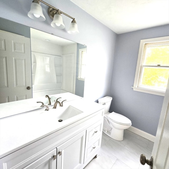 bathroom with walk in shower, vanity, and toilet