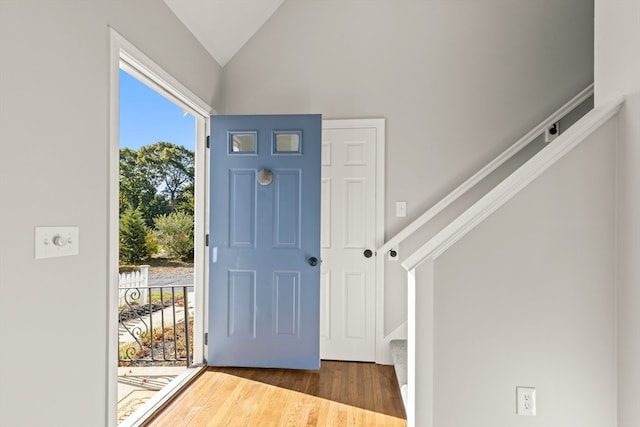 entryway featuring dark hardwood / wood-style floors and vaulted ceiling