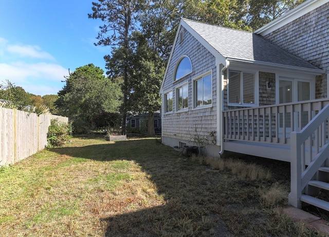 view of side of property with a lawn