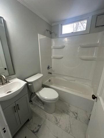 bathroom featuring toilet, vanity, marble finish floor, and shower / bath combination