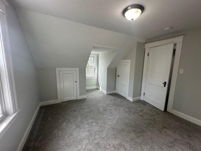 bonus room with vaulted ceiling, carpet, and baseboards