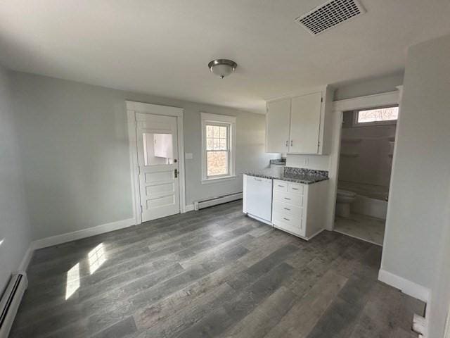 kitchen with visible vents, baseboards, white cabinetry, and a baseboard radiator