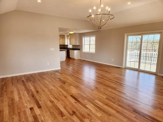 53 Kelly Ln, Lynn, MA 01904 - interior space with a notable chandelier, light wood-type flooring, baseboards, lofted ceiling, and recessed lighting