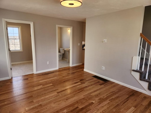 53 Kelly Ln, Lynn, MA 01904 - spare room with visible vents, baseboards, stairs, and wood finished floors