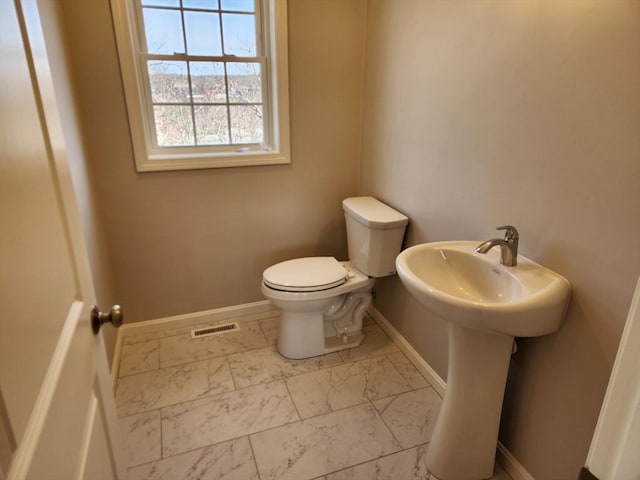 53 Kelly Ln, Lynn, MA 01904 - half bathroom with visible vents, a sink, baseboards, toilet, and marble finish floor