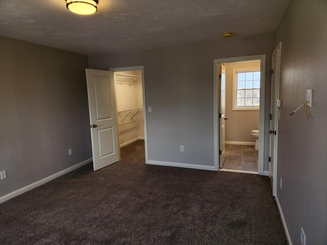 53 Kelly Ln, Lynn, MA 01904 - unfurnished bedroom with connected bathroom, baseboards, a walk in closet, and a closet