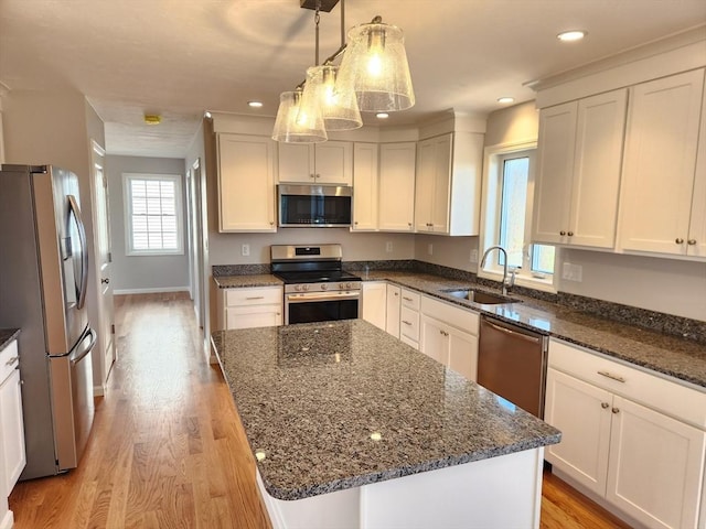 53 Kelly Ln, Lynn, MA 01904 - kitchen with a sink, appliances with stainless steel finishes, light wood-type flooring, and dark stone counters