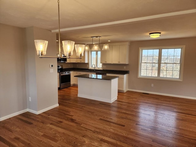 53 Kelly Ln, Lynn, MA 01904 - kitchen featuring white cabinets, dark wood-style flooring, appliances with stainless steel finishes, an inviting chandelier, and a wealth of natural light