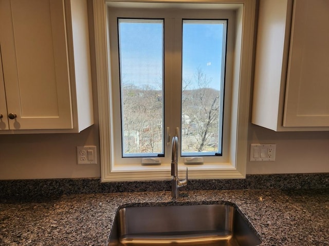 53 Kelly Ln, Lynn, MA 01904 - details with a sink, dark stone countertops, and white cabinets