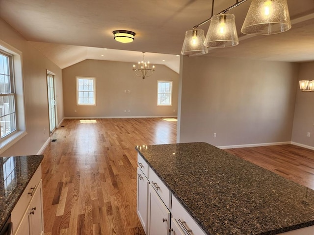 53 Kelly Ln, Lynn, MA 01904 - interior space with open floor plan, an inviting chandelier, light wood finished floors, and lofted ceiling