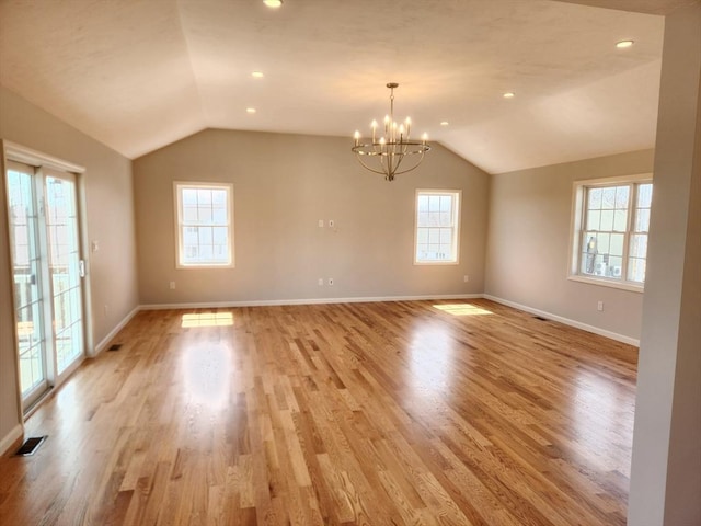 53 Kelly Ln, Lynn, MA 01904 - spare room with baseboards, a notable chandelier, lofted ceiling, and light wood-style floors