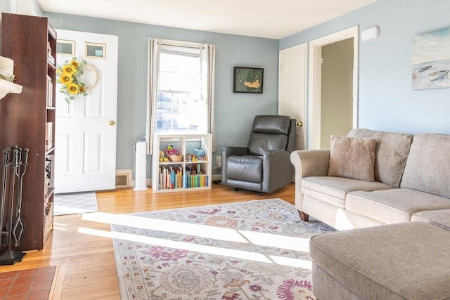 living area with visible vents and light wood-style flooring