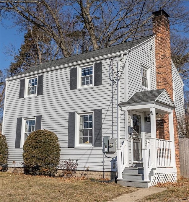 colonial-style house featuring a chimney