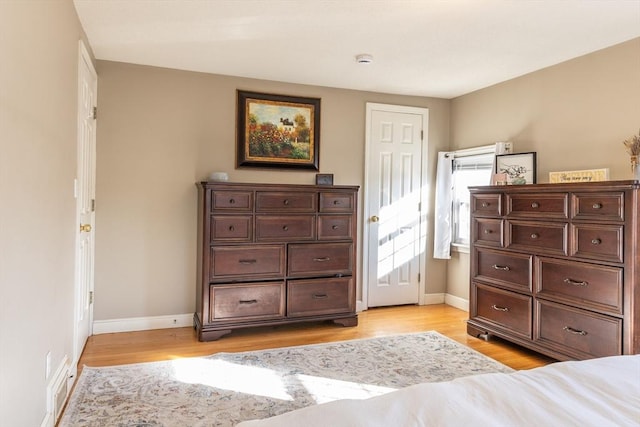 bedroom with visible vents, baseboards, and light wood-style floors