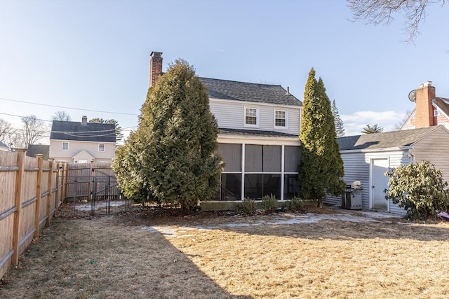 back of house with a sunroom and fence