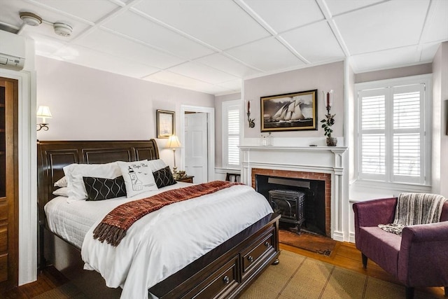 bedroom with a wall mounted AC and multiple windows