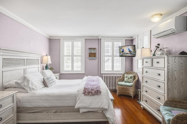 bedroom with radiator heating unit, a wall mounted air conditioner, dark wood-type flooring, and multiple windows