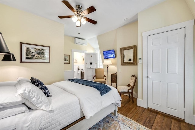 bedroom featuring a wall unit AC, dark wood-type flooring, a ceiling fan, and baseboards