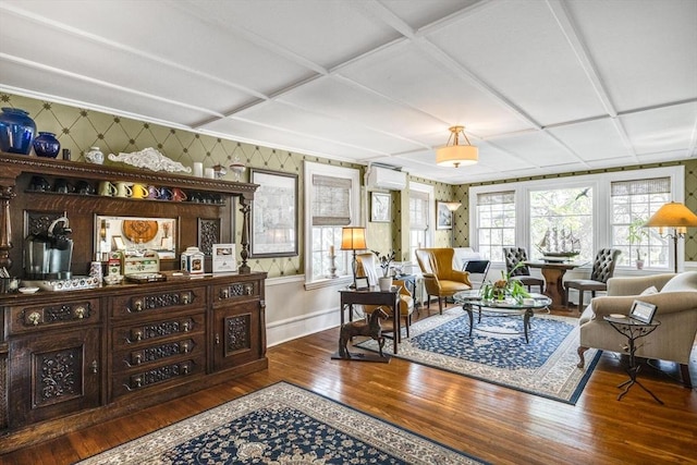 living area featuring wood finished floors, an AC wall unit, baseboards, and wallpapered walls