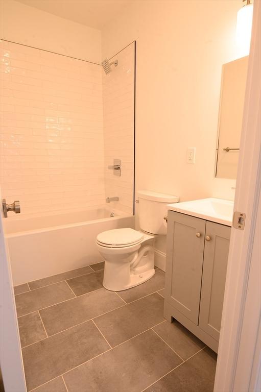 8 Brookside Ave Unit 2, Boston, MA 02130 - full bathroom featuring vanity, toilet, shower / bath combination, and tile patterned flooring