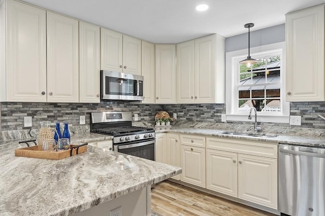 33 N Shore Rd, Westminster, MA 01473 - kitchen featuring stainless steel appliances, decorative backsplash, light stone countertops, hanging light fixtures, and recessed lighting