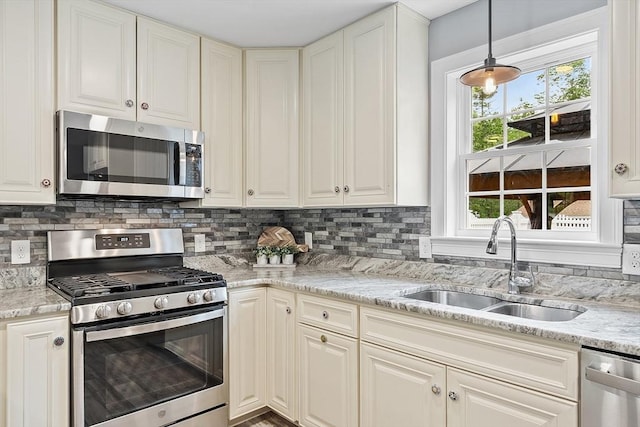 33 N Shore Rd, Westminster, MA 01473 - kitchen with stainless steel appliances, tasteful backsplash, light stone counters, and hanging light fixtures