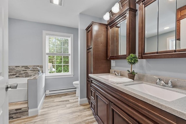 33 N Shore Rd, Westminster, MA 01473 - full bath with a baseboard radiator, double vanity, wood finished floors, and a garden tub