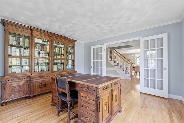 office area featuring a notable chandelier, ornamental molding, french doors, and light wood-style floors